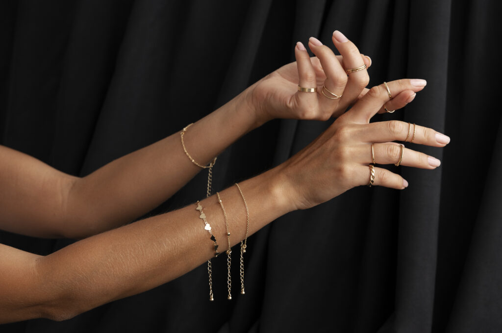 photo woman's arms wearing golden bracelet jewelry